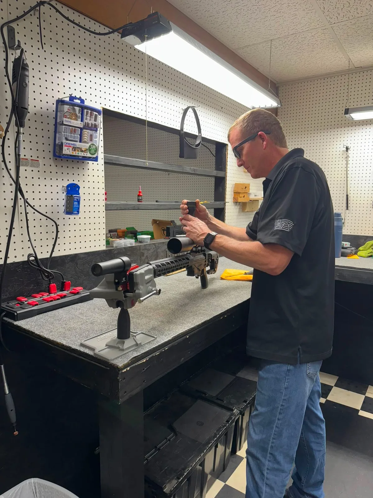 Gunsmith Jason Jordan working at the bench at Drop Tine Guns in Staunton, VA