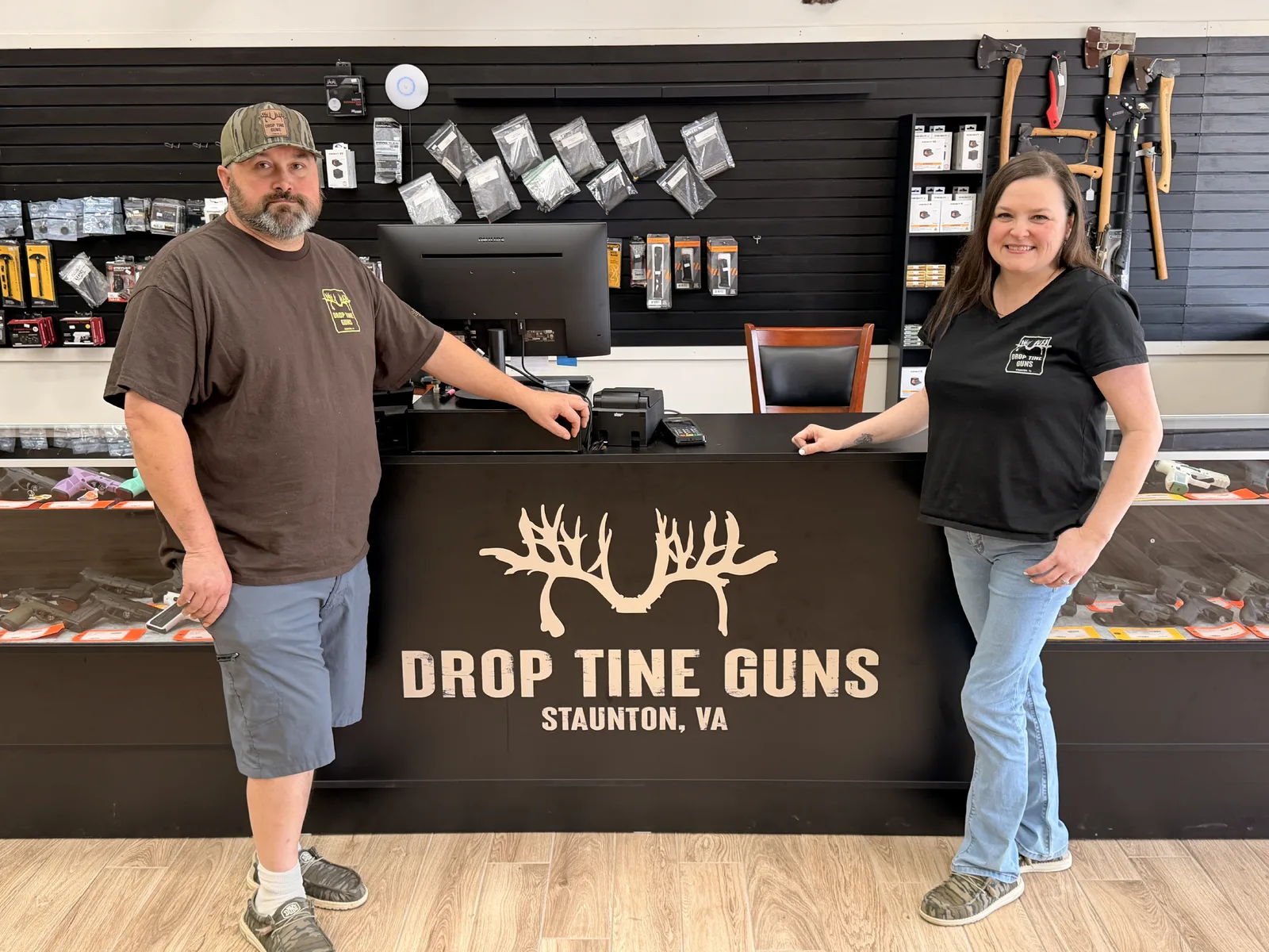 Brandon and Heather behind the counter at Drop Tine Guns