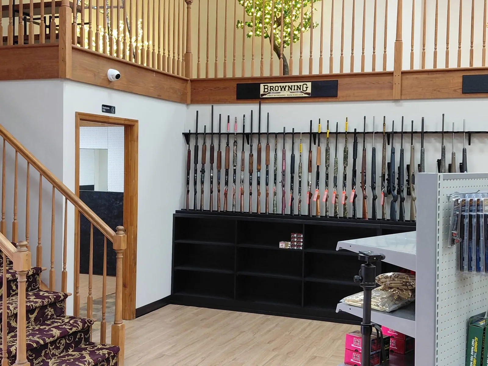 A wide view across the display cases and wall racks inside Drop Tine Guns