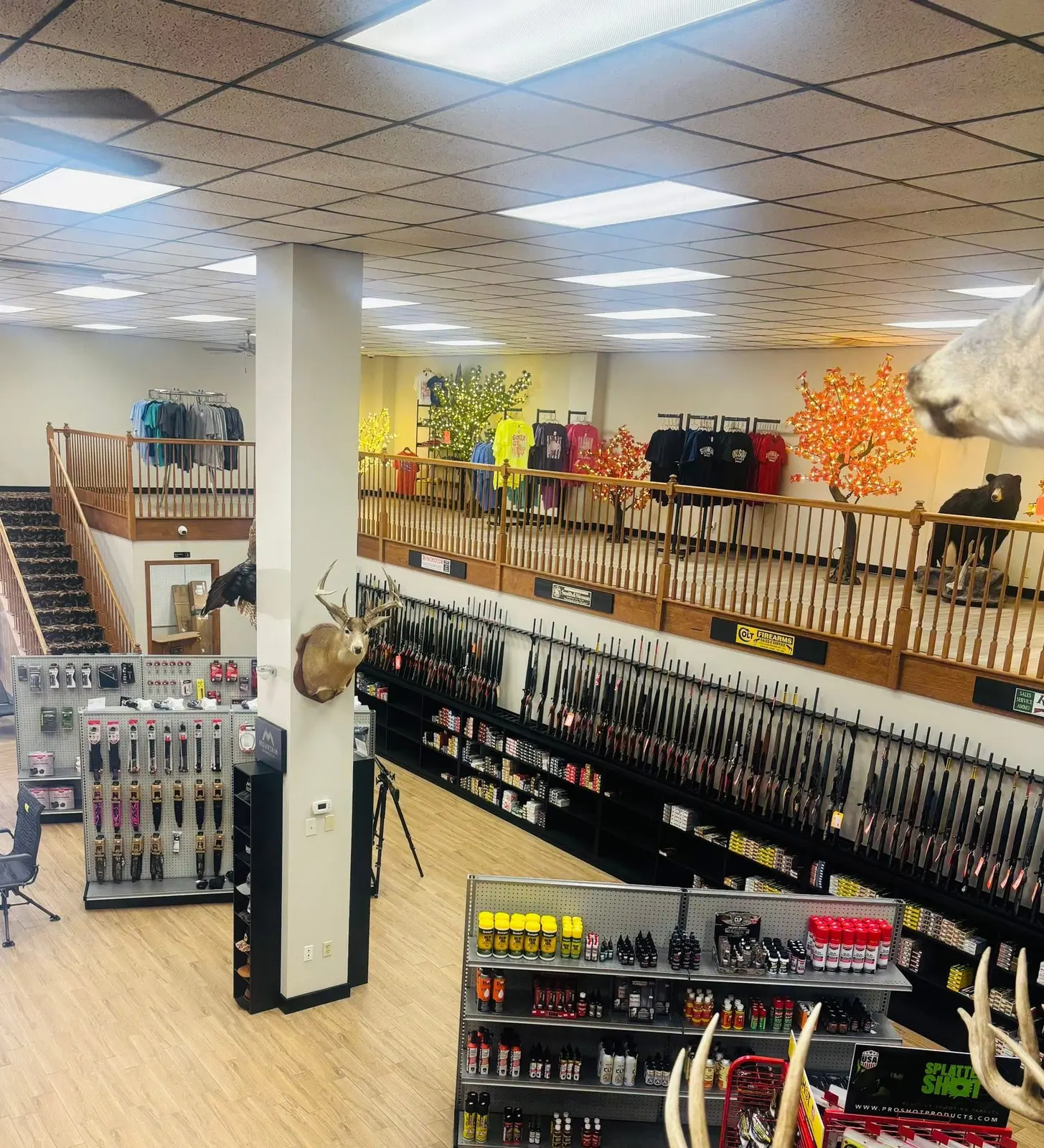 Inside the shop, looking across the rifle wall toward the upstairs apparel loft